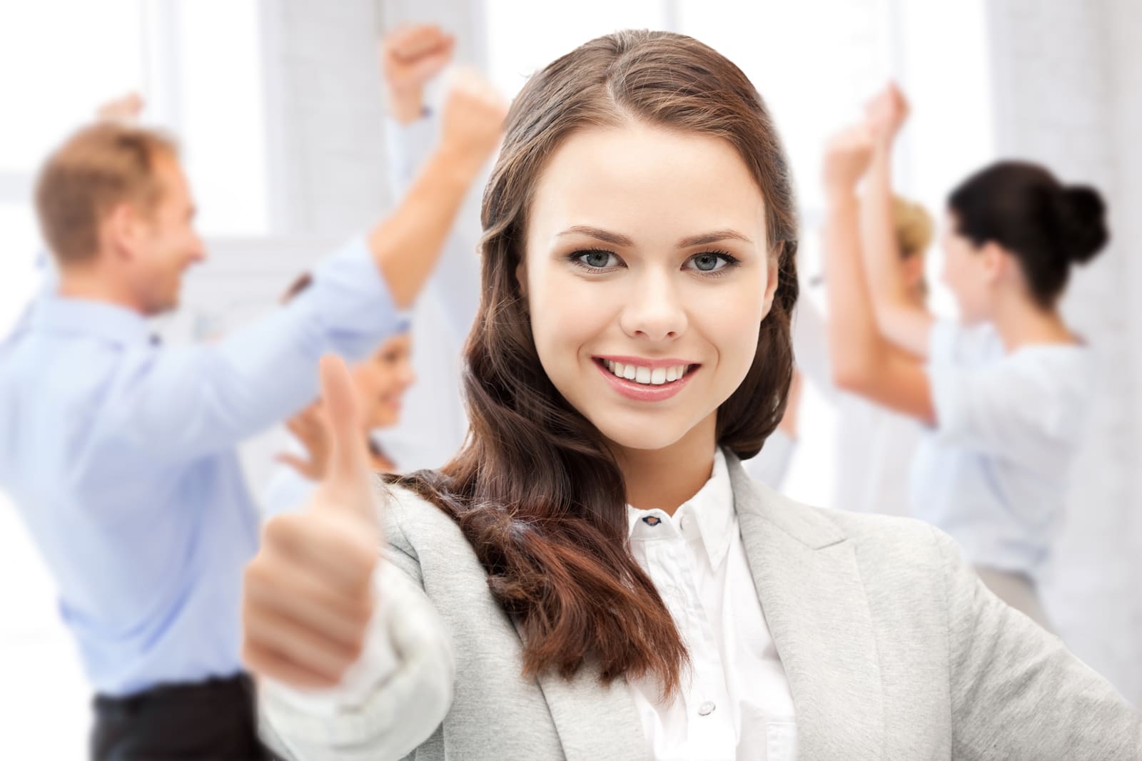 13684334_businesswoman-showing-thumbs-up-in-office